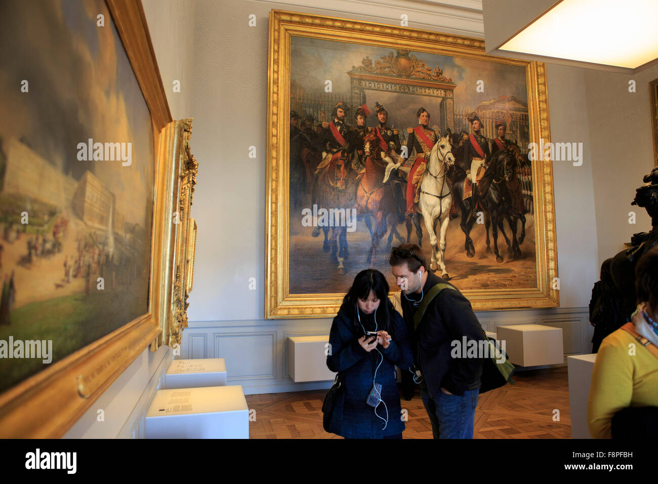 Watching a video on the audio guide provided at the Palace of Versailles, Paris, France Stock ...