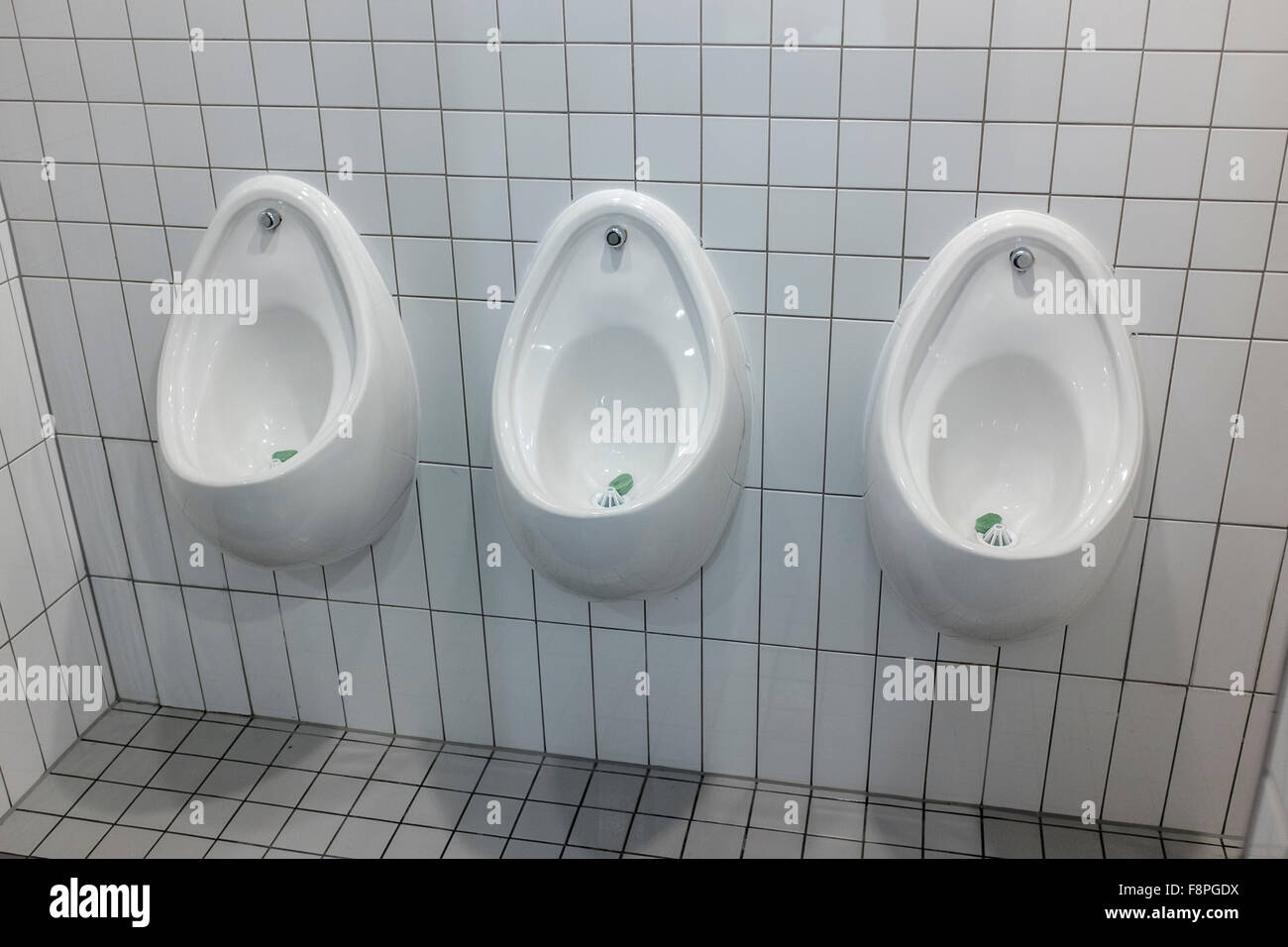 Urinals in public toilet Stock Photo