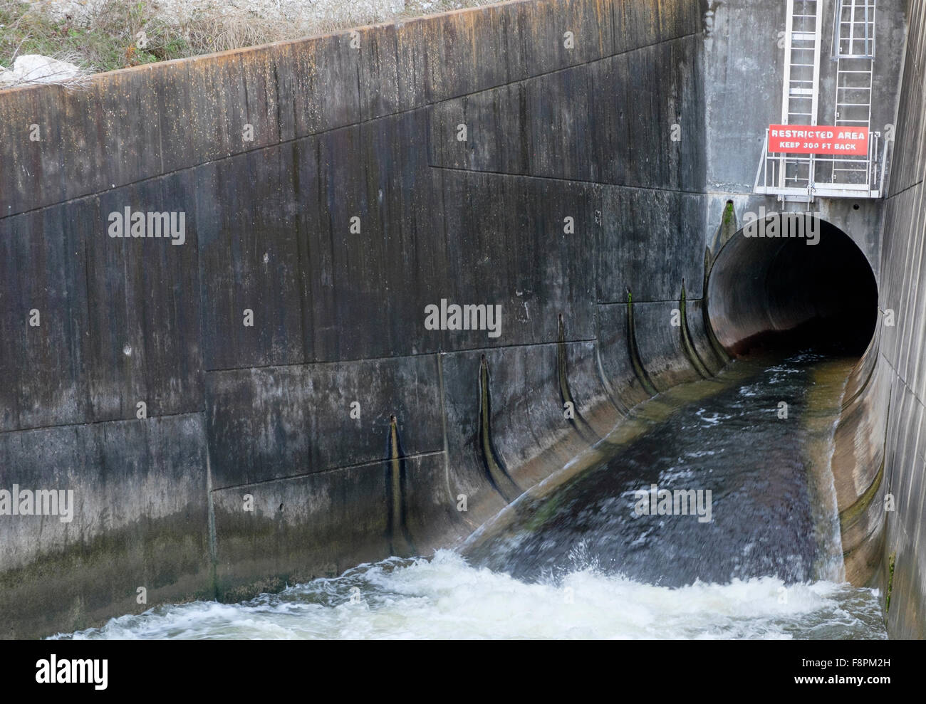 Flow tube water discharge below US Corps of Engineers dam Lake Georgetown Texas Stock Photo