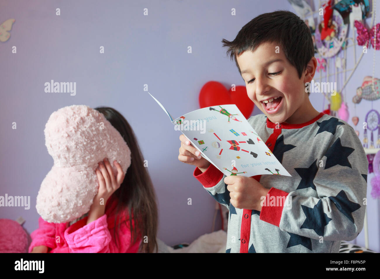 Child reading thank you card from Santa Stock Photo