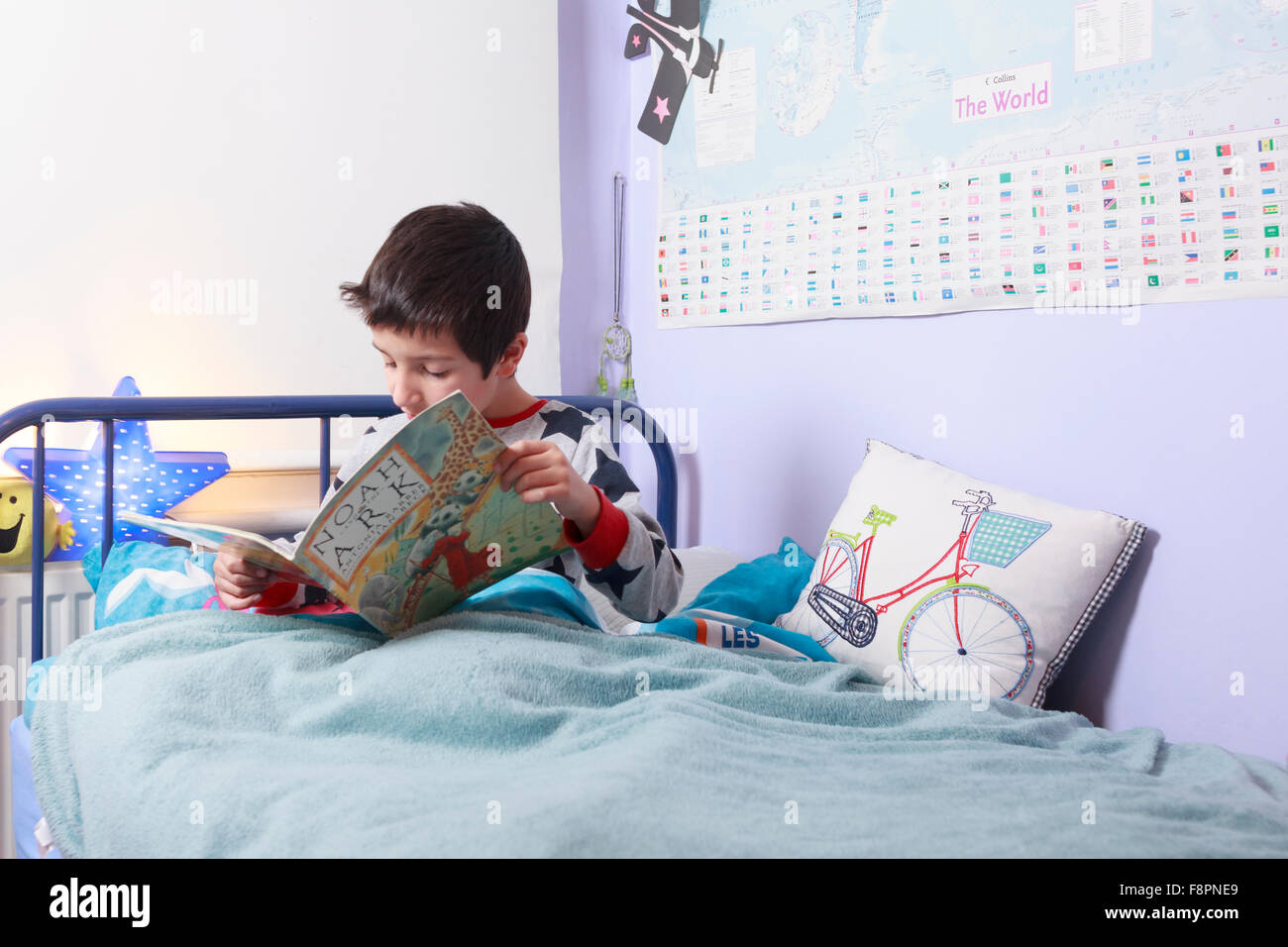 Child reading in bed Stock Photo