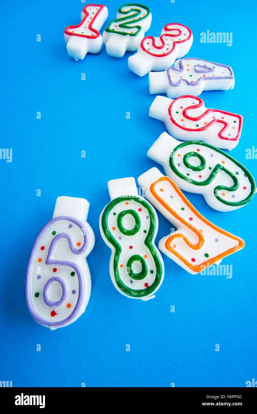 Birthday candles against colourful background Stock Photo - Alamy