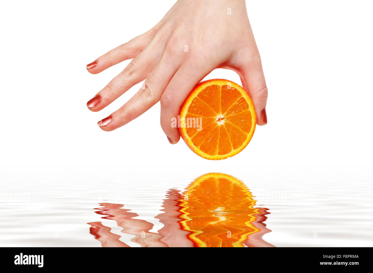 Hand holding half cut orange hi-res stock photography and images - Alamy