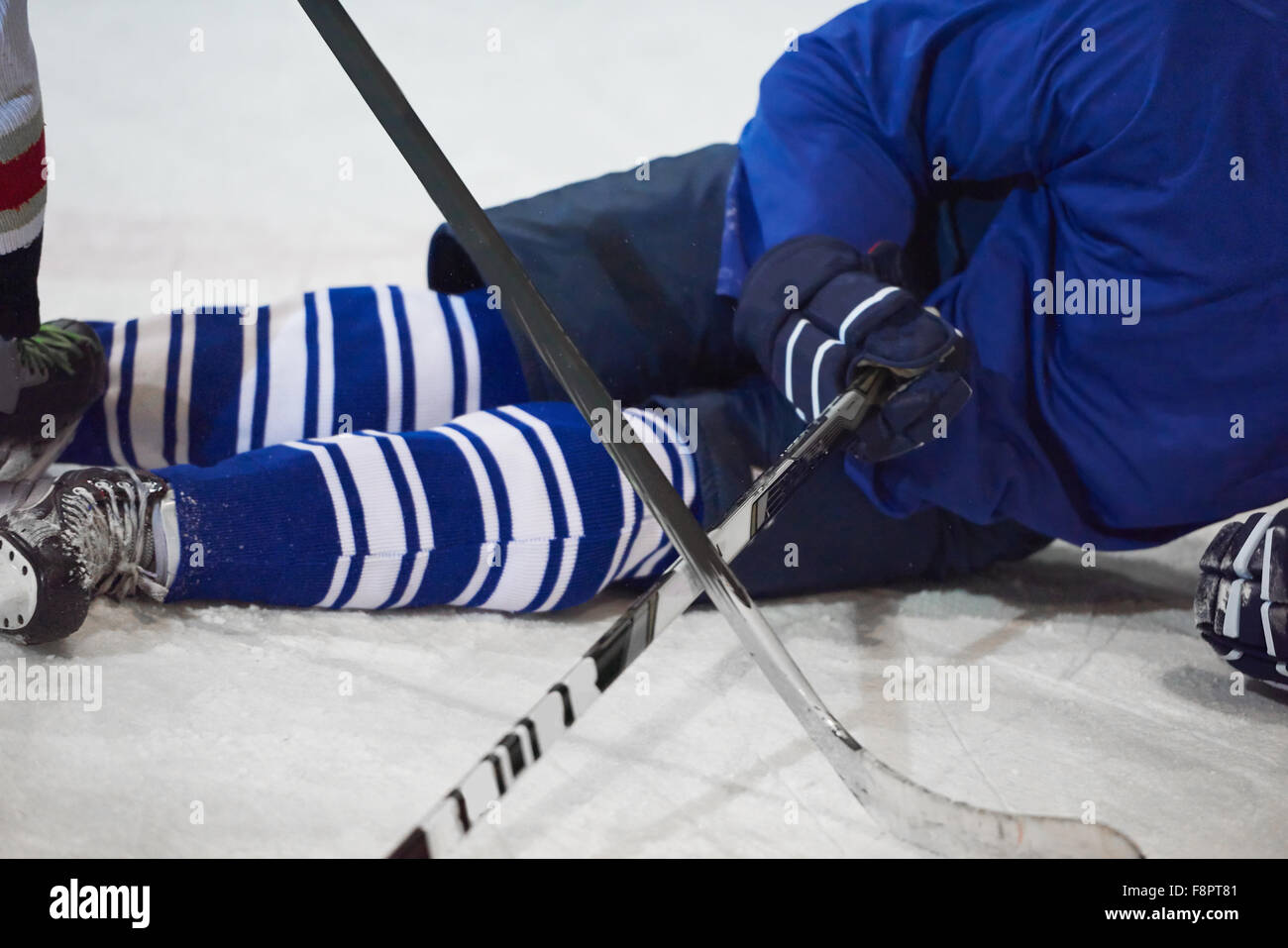 ice hockey player in action kicking with stick Stock Photo Alamy
