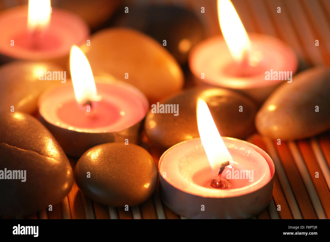 Aromatic candles and pebbles for spa session Stock Photo Alamy