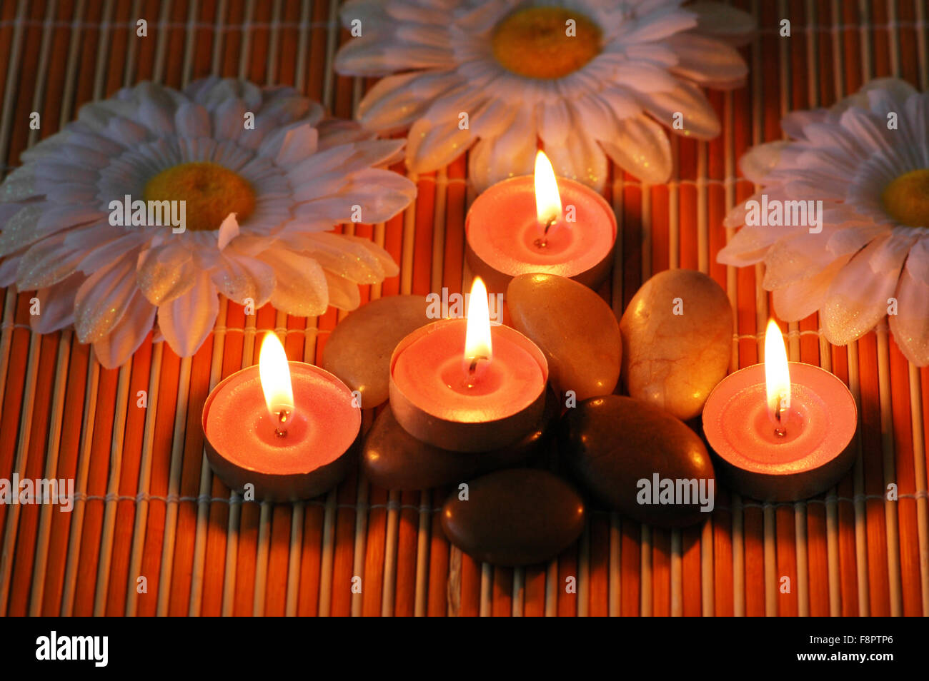 Aromatic candles and pebbles for spa session Stock Photo Alamy
