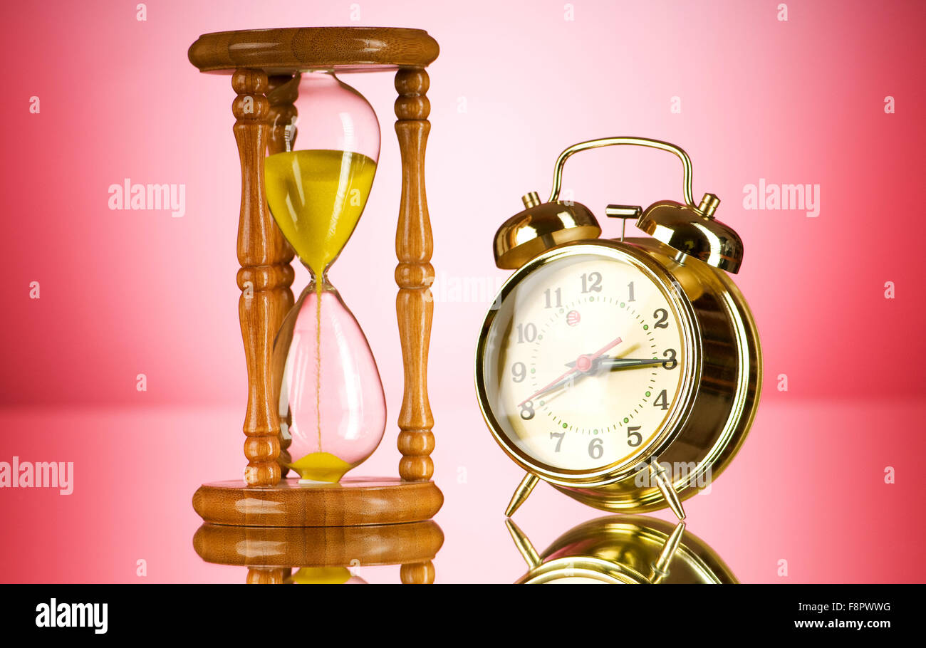 Time concept with clock and hour glass Stock Photo Alamy