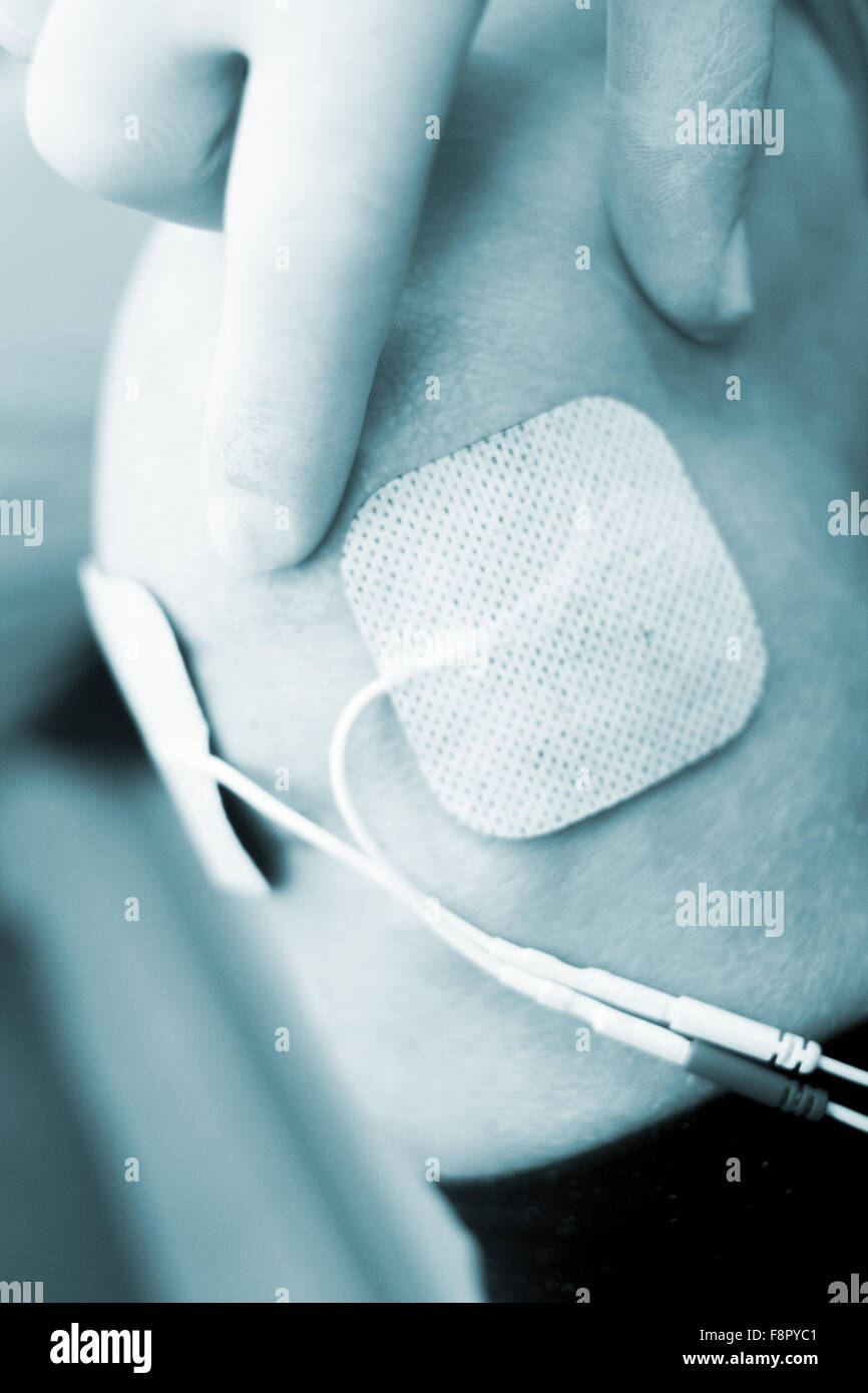 Patient leg and knee in electro physiotherapy electrical impulse