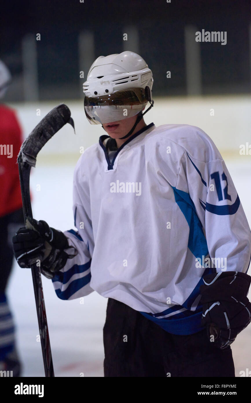 young ice hockey player portrait on training in black background Stock