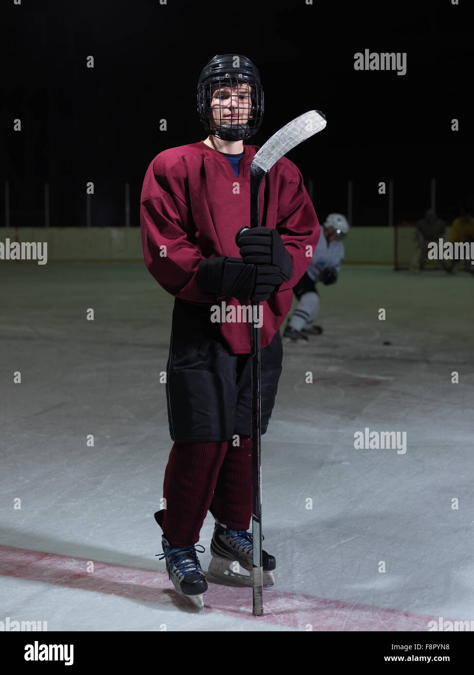 young ice hockey player portrait on training in black background Stock