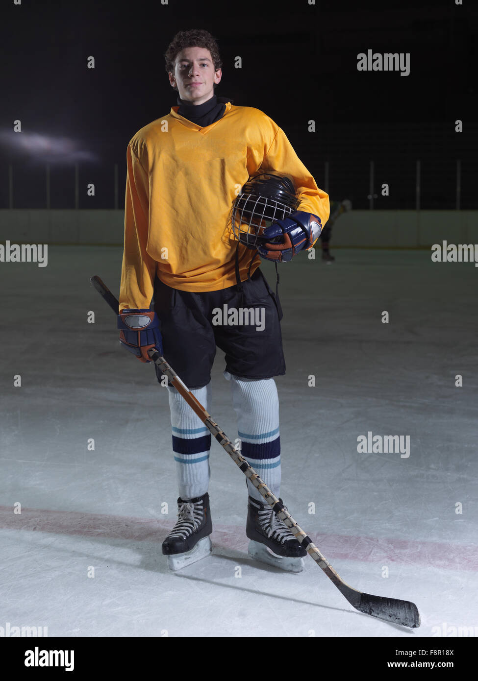 young ice hockey player portrait on training in black background Stock