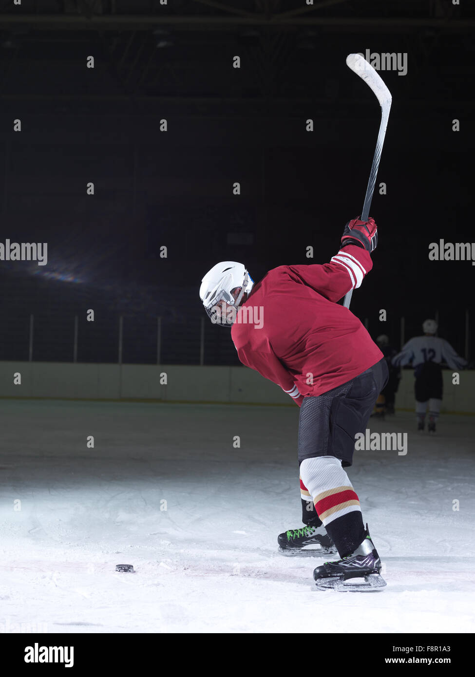 ice hockey player in action kicking with stick Stock Photo Alamy