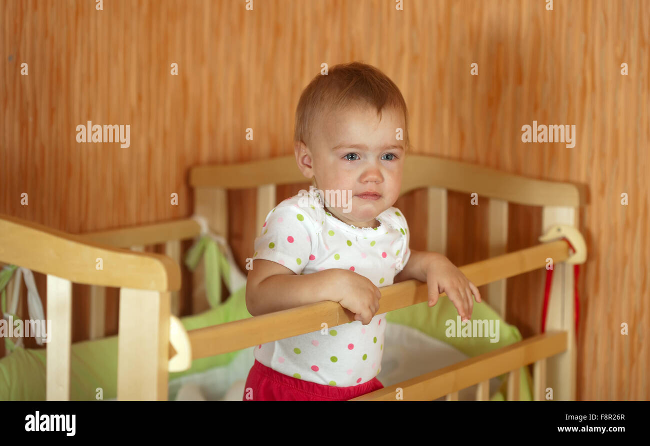 Crying baby of one year old in crib Stock Photo Alamy