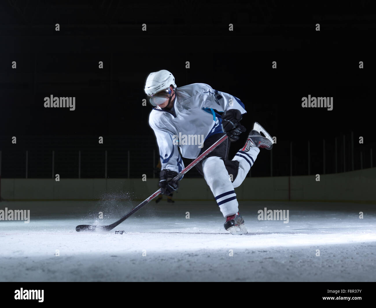 ice hockey player in action kicking with stick Stock Photo Alamy