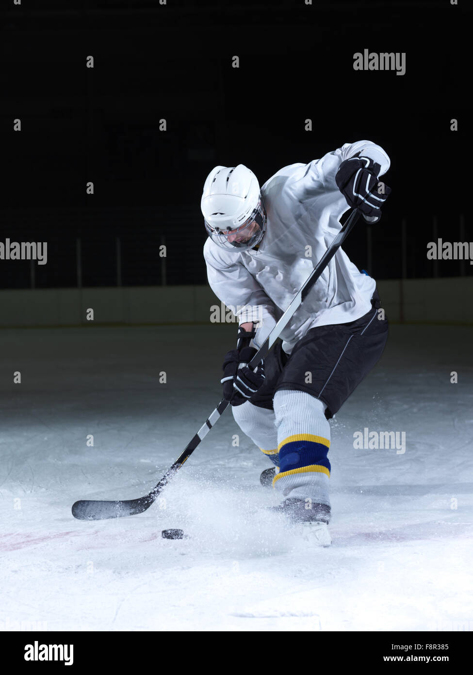 ice hockey player in action kicking with stick Stock Photo Alamy