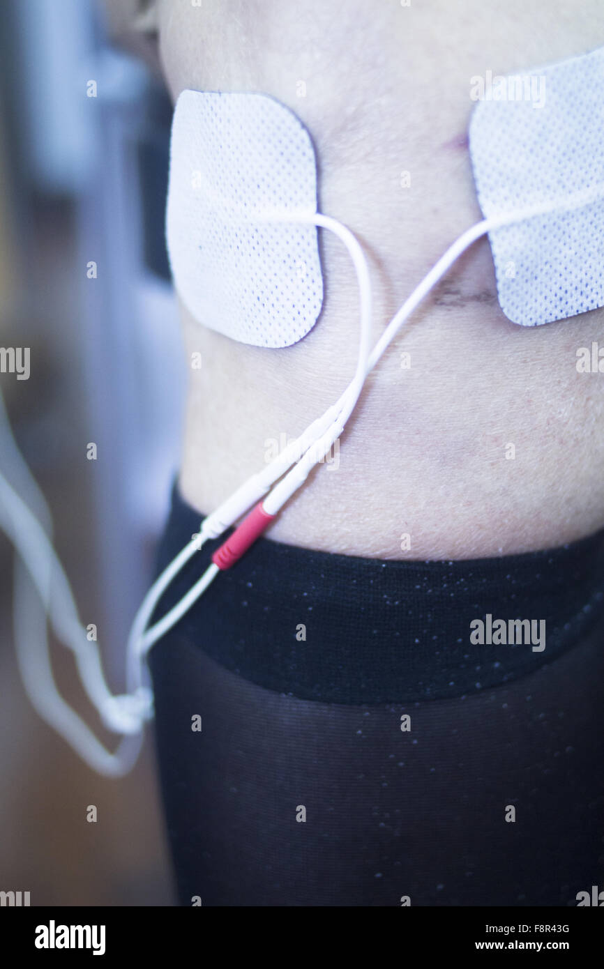 Patient leg and knee in electro physiotherapy electrical impulse