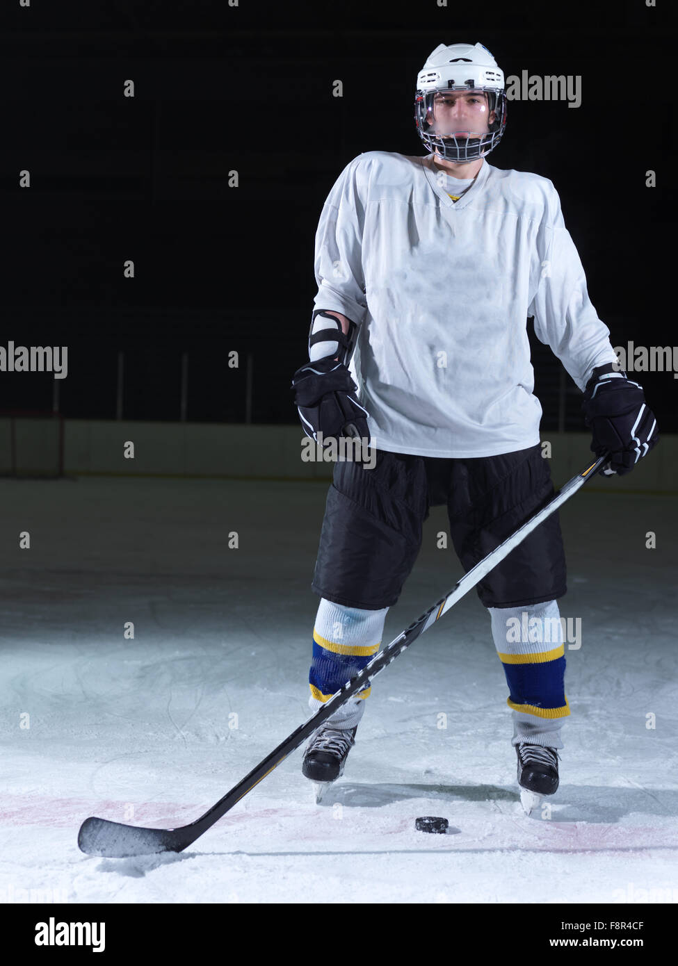 young ice hockey player portrait on training in black background Stock