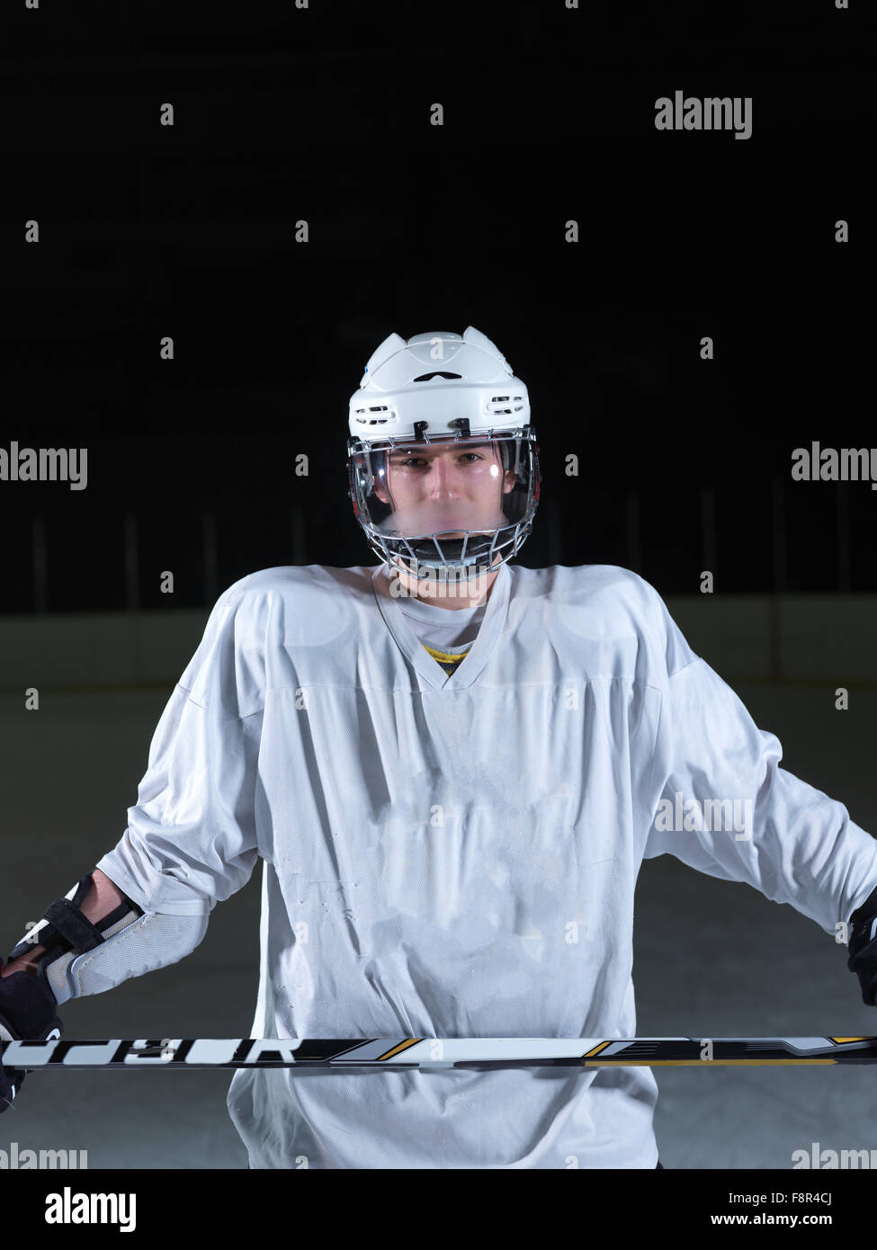 young ice hockey player portrait on training in black background Stock