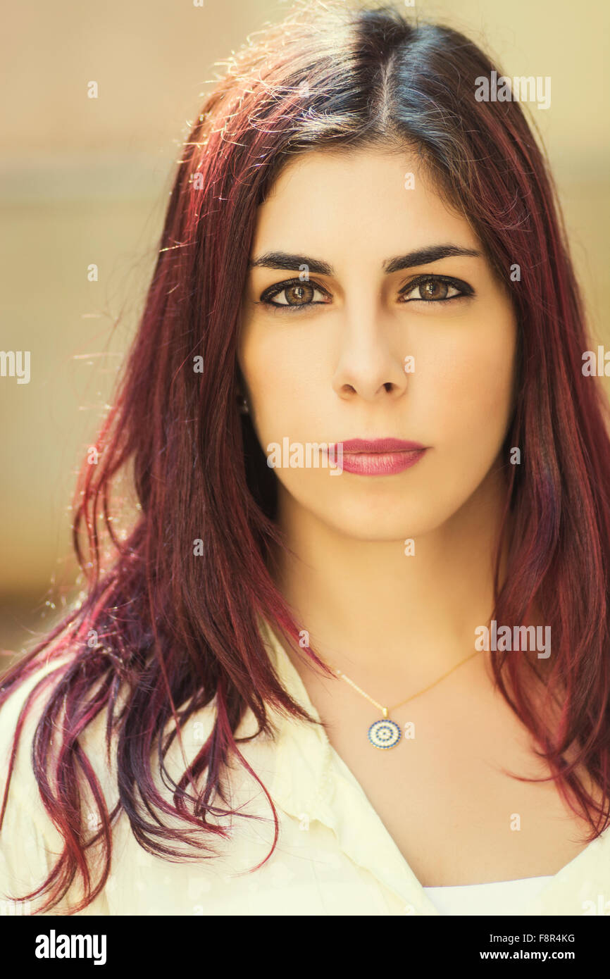 Serious young woman staring outdoors Stock Photo