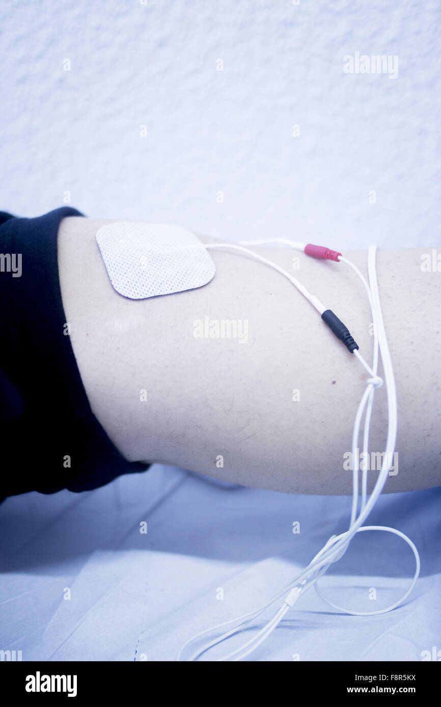Patient leg and knee in electro physiotherapy electrical impulse stimulation rehabiliation