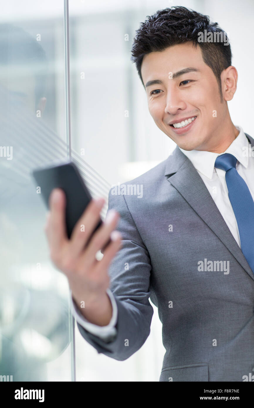 Young businessman using smart phone Stock Photo - Alamy