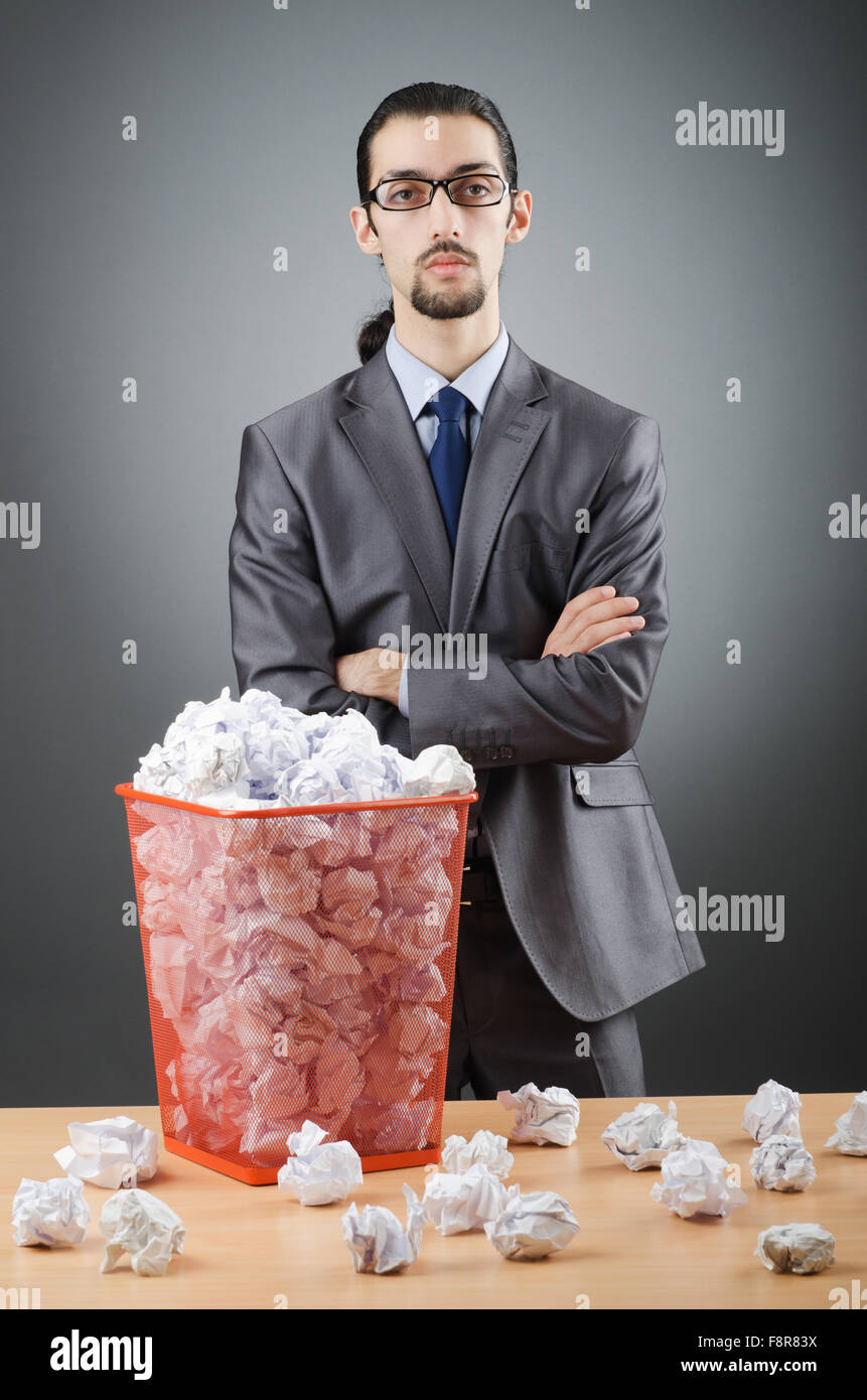Man with lots of wasted paper Stock Photo - Alamy