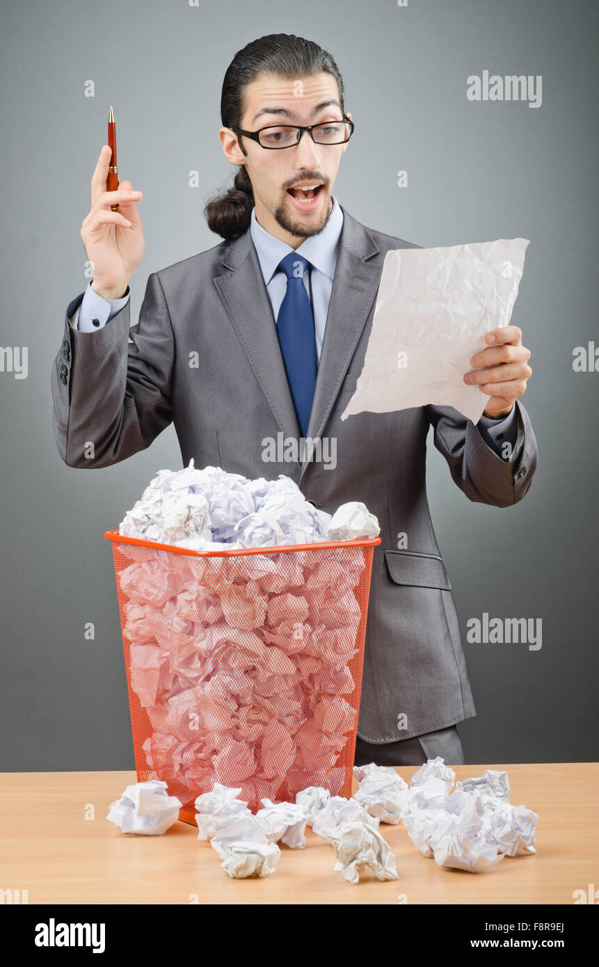 Man with lots of wasted paper Stock Photo - Alamy