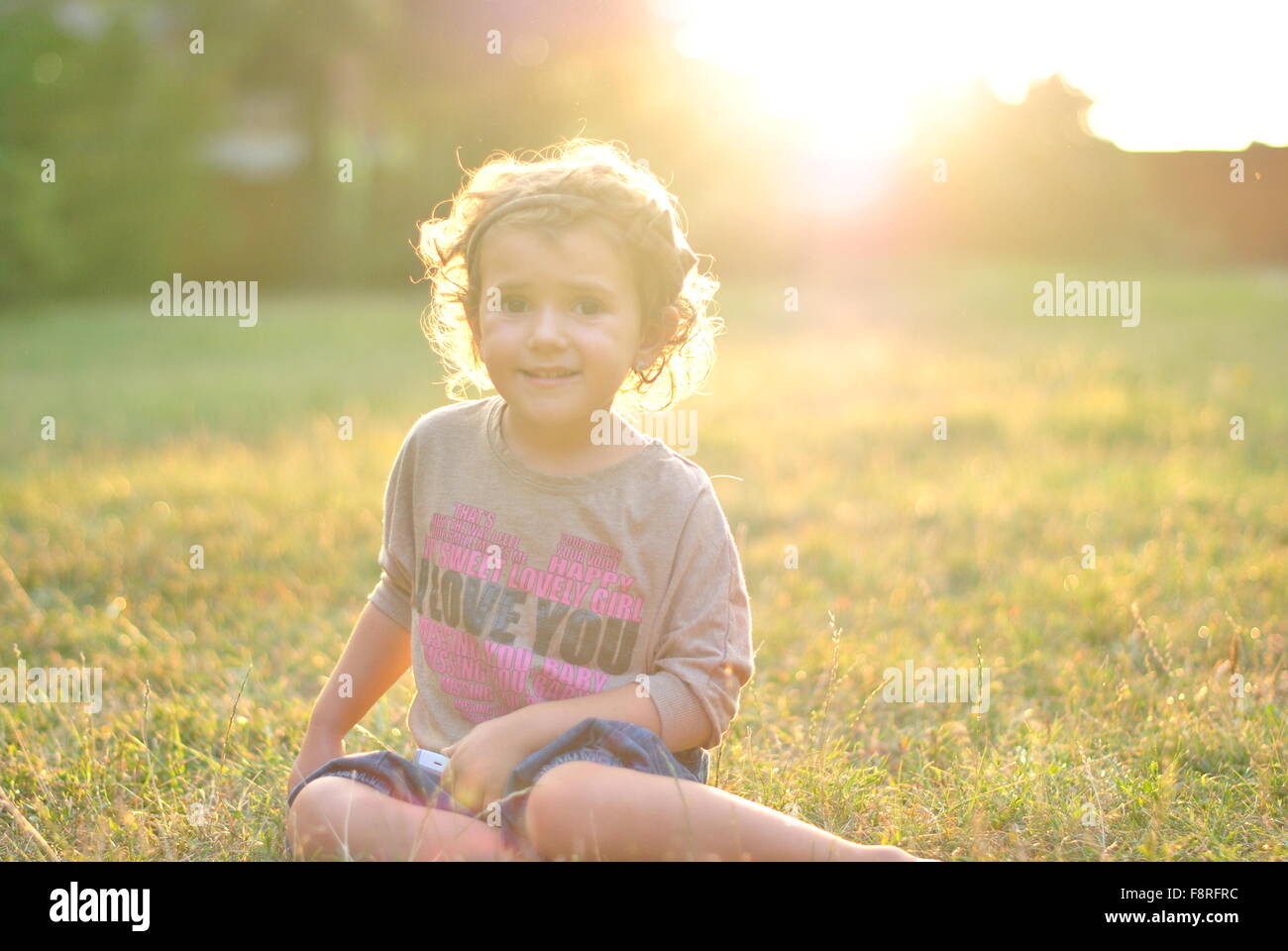Portrait of a girl sitting on grass Stock Photo