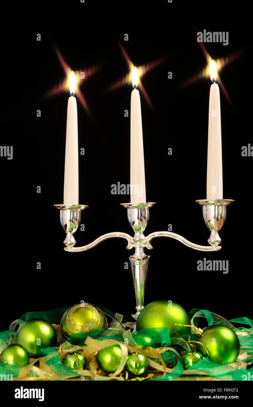 candlestick with three candles and green beads as Christmas and New Year decoration Stock Photo