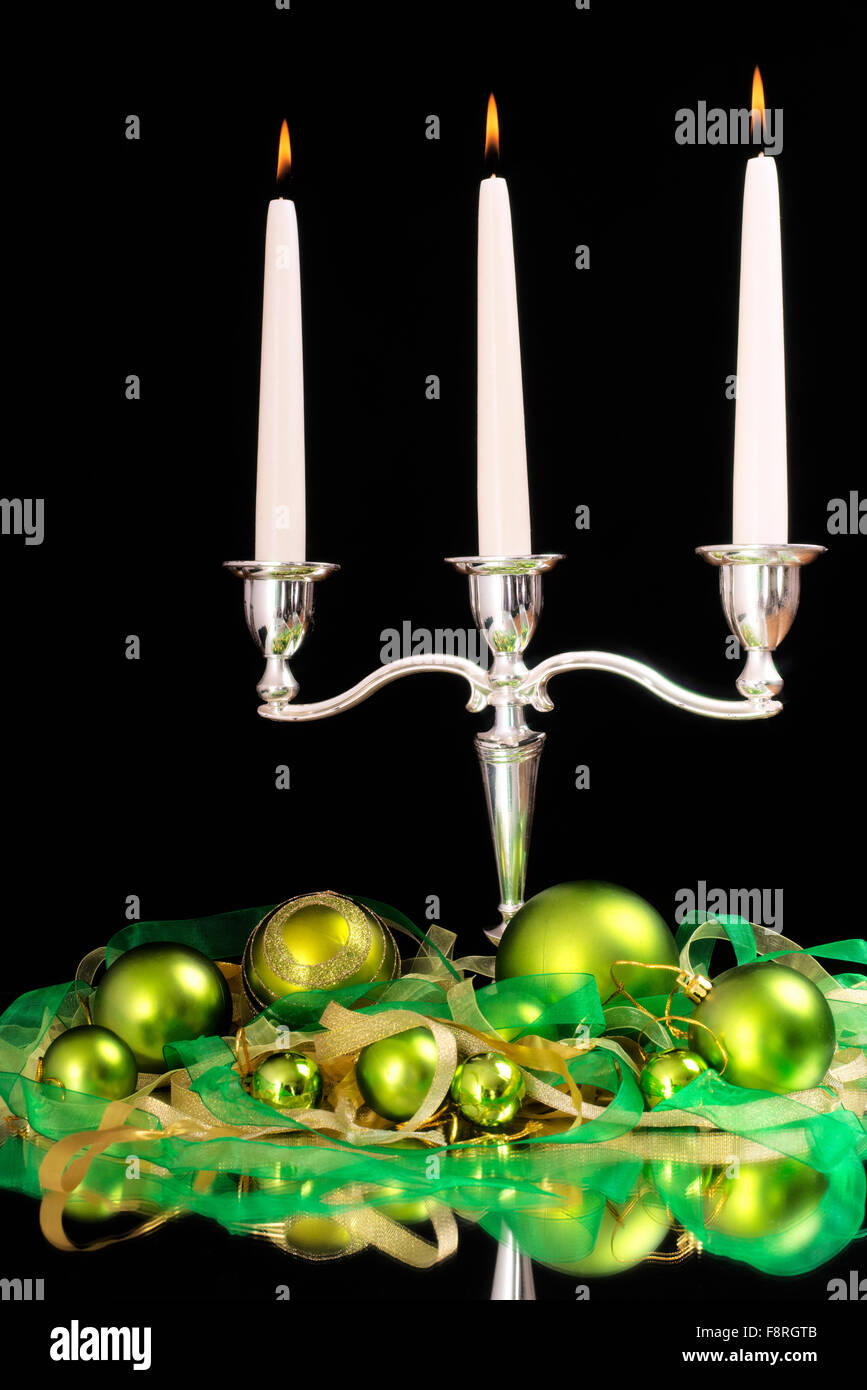 candlestick with three candles and green beads as Christmas and New Year decoration Stock Photo