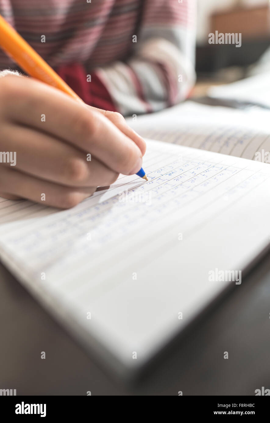 Boy writing in a notebook Stock Photo