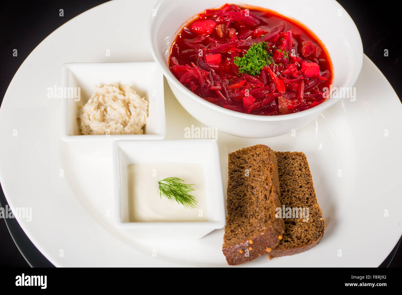 Borsch with creme fraiche, lard and bread Stock Photo