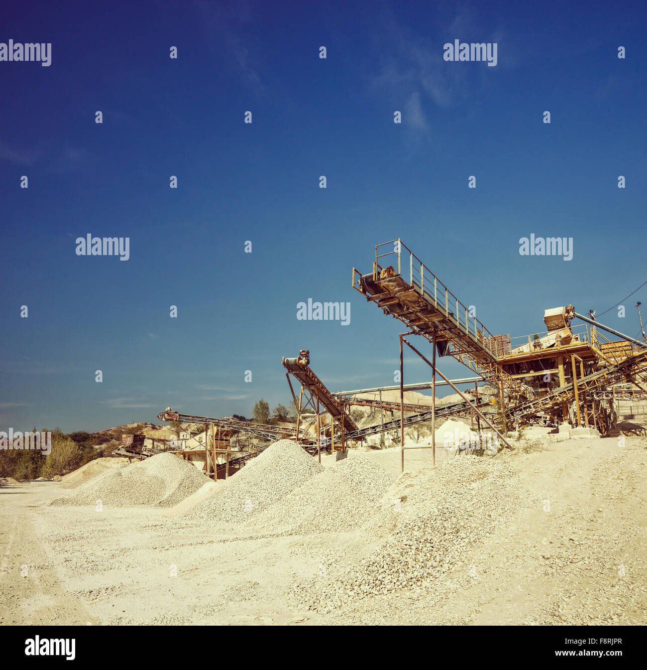 Conveyor belts and machinery at a gravel pit shot on a clear sunny day shot with tilt and shift lens Stock Photo