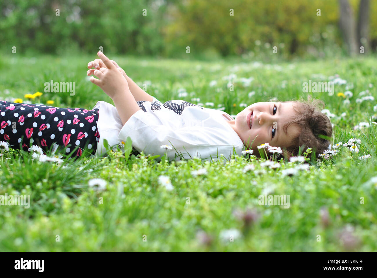 Girl lying on the grass in park Stock Photo