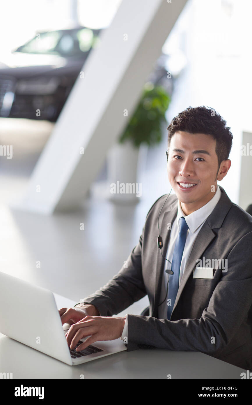 Car salesman working with laptop Stock Photo Alamy