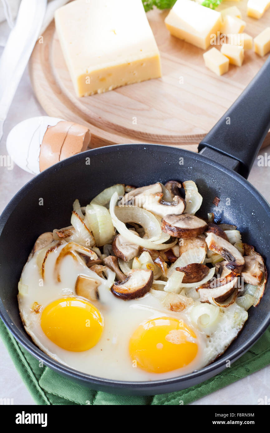Scrambled Eggs With Mushrooms To Frying Pan Sliced Cheese And Herbs Stock Photo Alamy