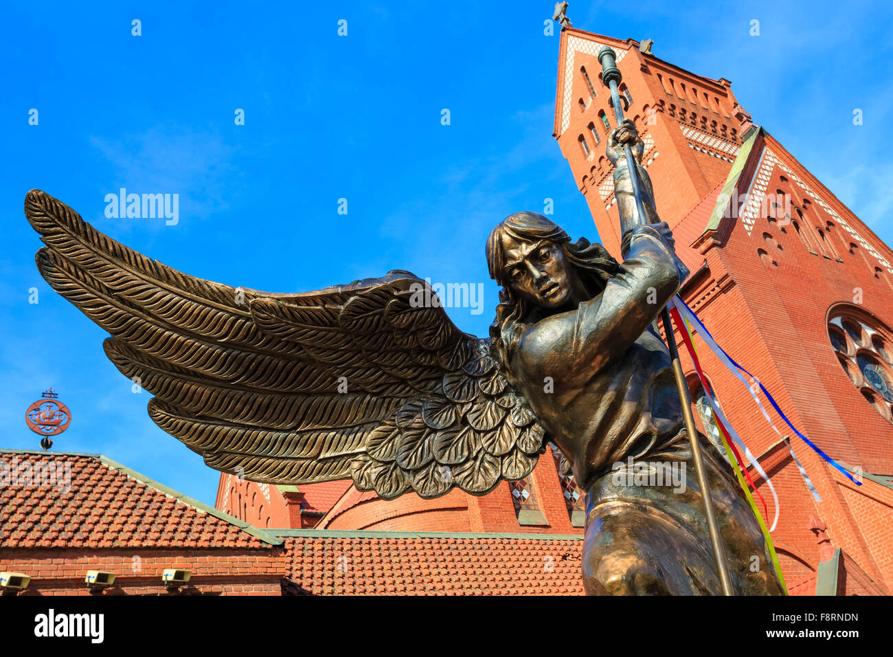 Statue of Archangel Michael with outstretched wings, thrusting a spear into a dragon before the Catholic Church of St. Simon and Stock Photo