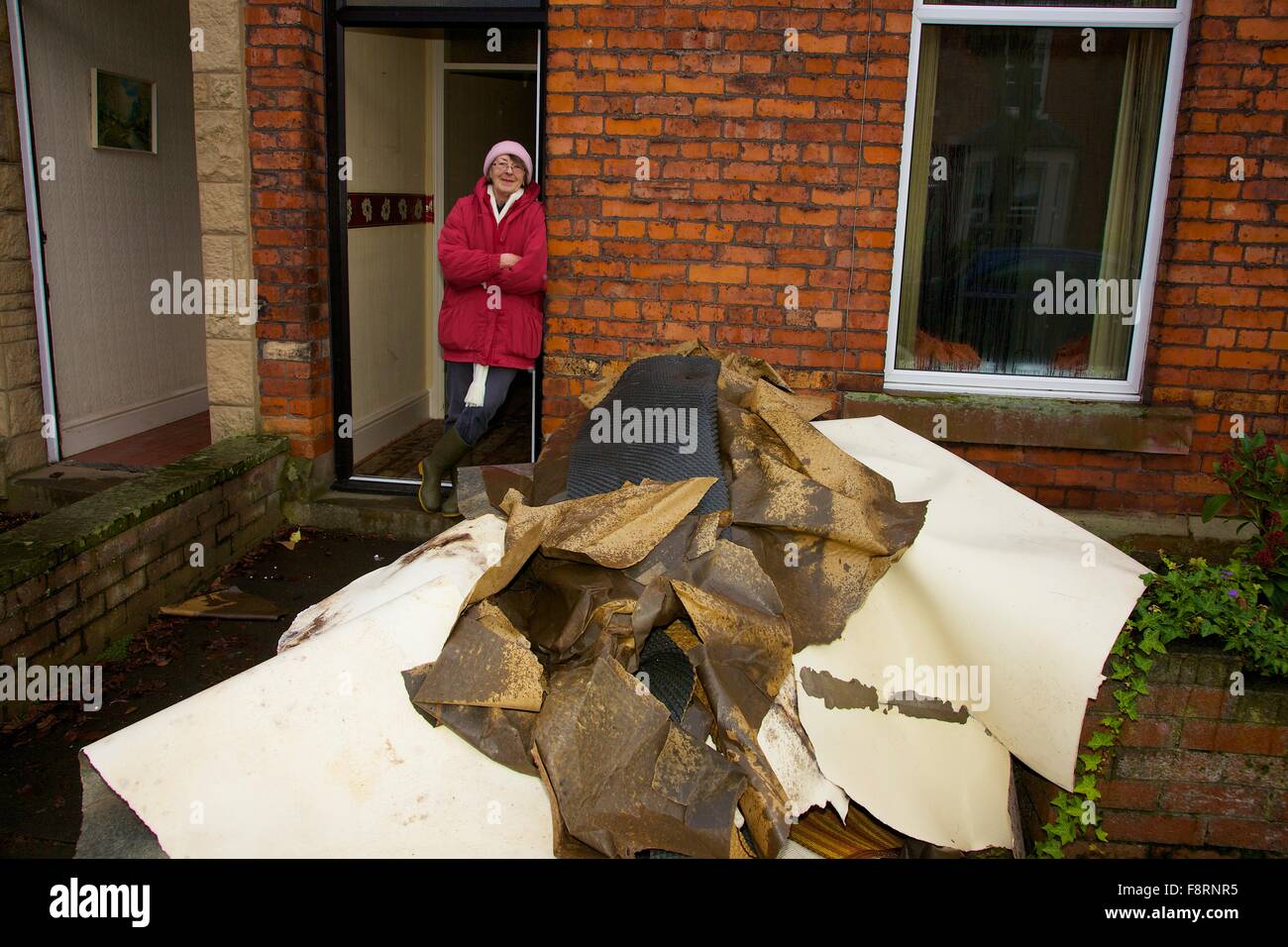 Carlisle, Cumbria, UK. 11th Dec, 2015. Weather and flood damage. Woman standing with her flood damaged furniture. Storm Desmond caused severe flooding in Carlisle and across Cumbria. Carlisle, Cumbria, England, UK. Credit:  Andrew Findlay/Alamy Live News Stock Photo