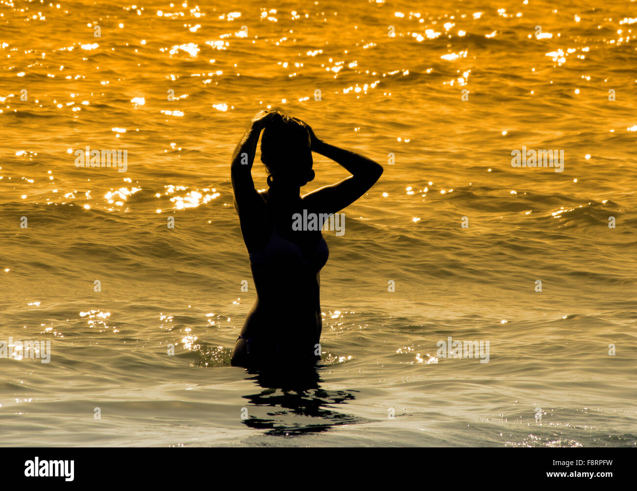 Silhouette of girl on the sea Stock Photo - Alamy