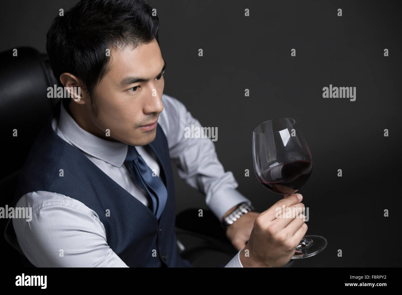 Confident businessman enjoying red wine Stock Photo Alamy