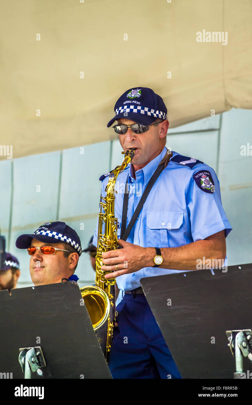 Uniformed male police officer saxophonist performing live with his ...