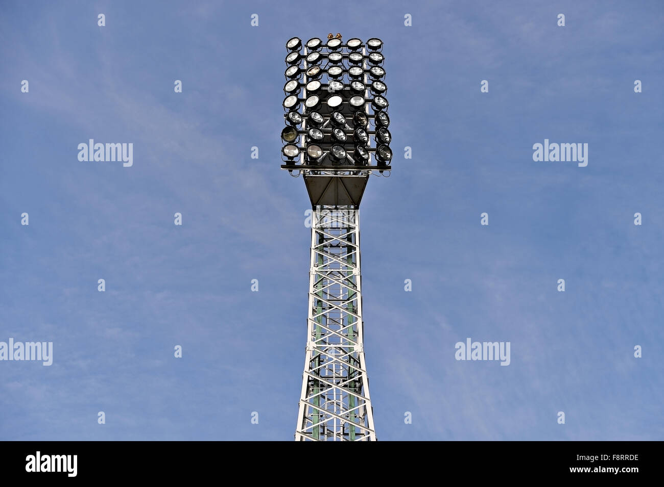 Spotlights detail on a sports arena floodlights isolated on a blue sky Stock Photo