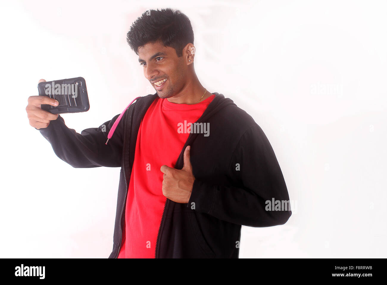 Cheerful indian teenager taking selfies with his mobile phone Stock Photo