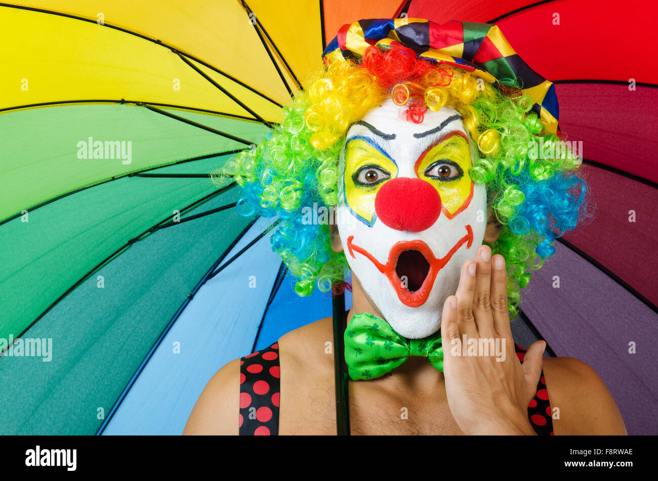 Clown with umbrella isolated on white Stock Photo