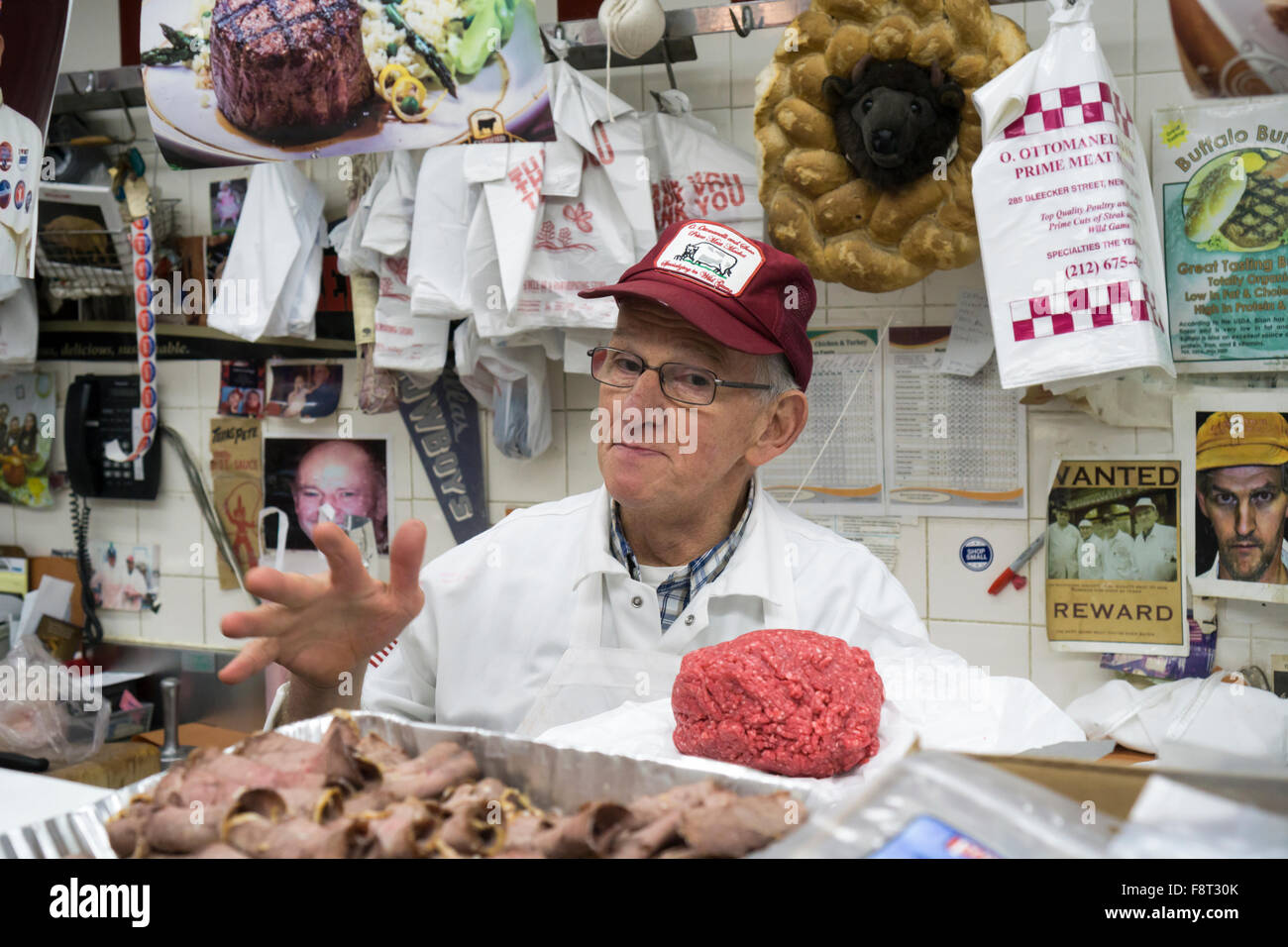 Frank Ottomanelli holding ground sirloin behind the counter at O