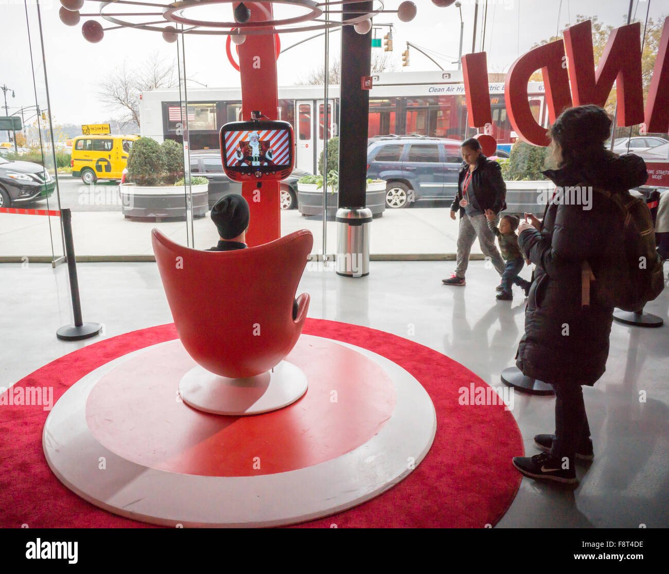 A visitor talks to Santa in the Target 'Wonderland!' pop-up store in the Meatpacking District in New York on its grand opening day, Wednesday, December 9, 2015. According to Target the store combines physical and digital shopping using medallions given to visitors with an embedded RFID chip. Tapping the chip to an antenna near the product lets you order it. The store is an experiment in technology replacing shopping carts with chips.  (© Richard B. Levine) Stock Photo