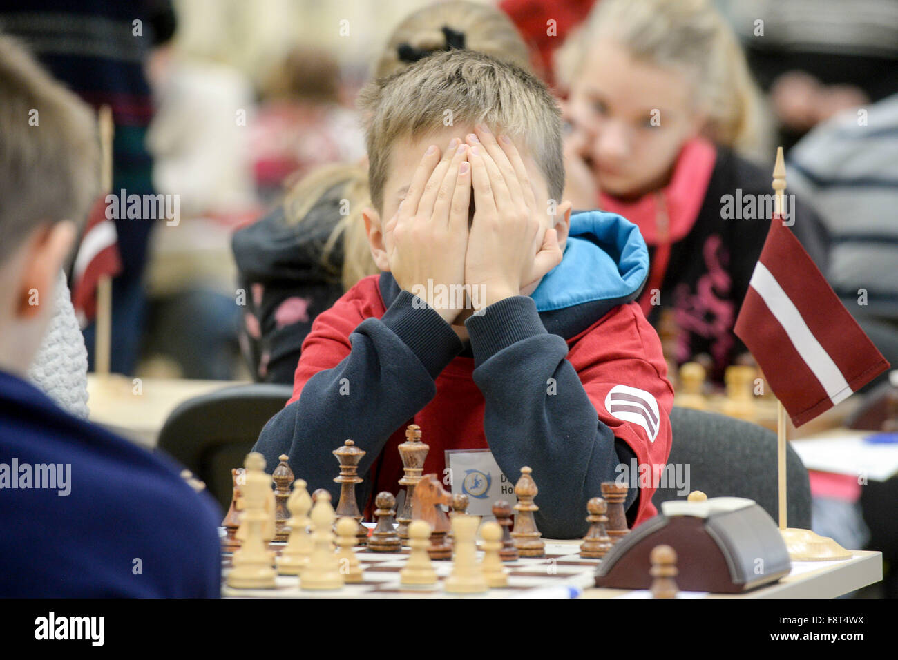 (151211) -- NARVA, Dec. 11, 2015 (Xinhua) -- A young chess player covers his face during 'The Starts of the Baltic Sea' chess tournament in Narva, third largest city of Estonia, on Dec. 11, 2015. Sixty young chess players aged 10 to 18 years old from Russia, Estonia, Finland, Latvia and Lithuania competed for the best World Chess Federation (FIDE) rating at this game. The game starts the FIDE celebration of 100 years of World famous Estonian Grandmaster Paul Keres (1916-1975) who was among the world's top players from the mid-1930s to the mid-1960s. Paul Keres was originally from Narva. (Xinhu Stock Photo