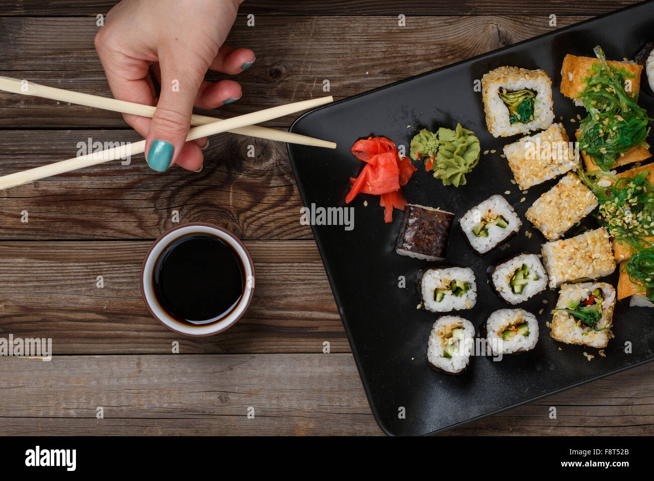 Sushi. Hand with chopsticks Stock Photo