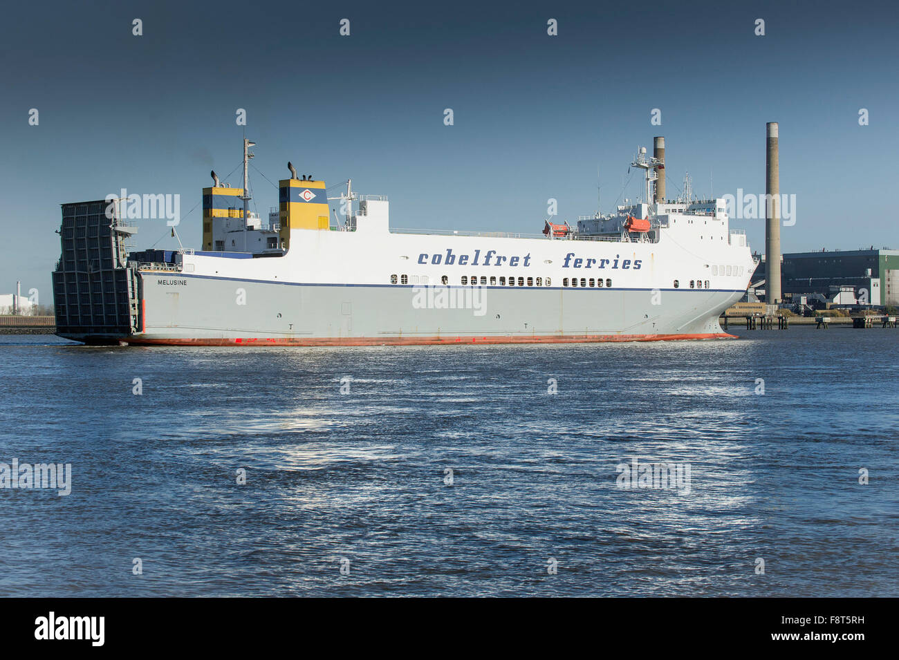On the River Thames, the Melusine, a Ro-Ro cargo ferry from the Cobelfret Ferries Line steams downriver. Stock Photo