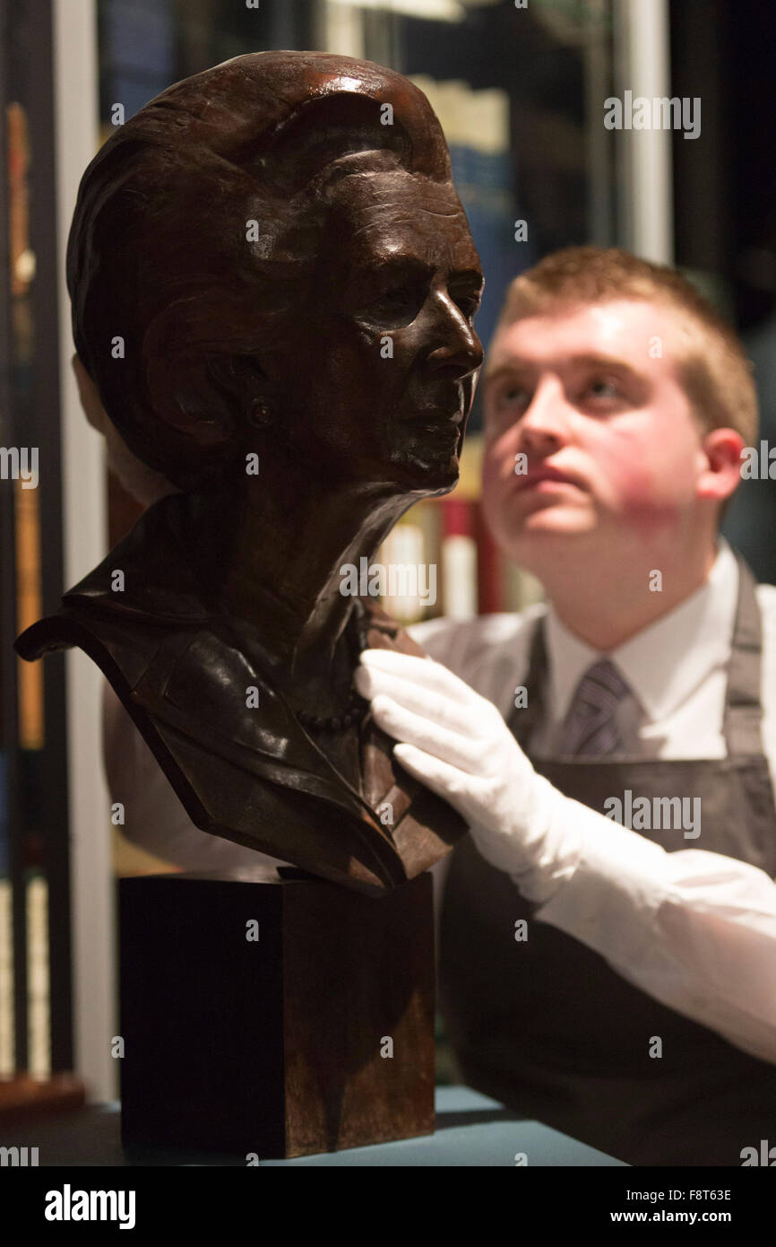 London, UK. 11 December 2015. A Christie's employee looks at a portrait bust of Baroness Thatcher by Neil Simmons. Est. GBP 700-1000. Mrs Thatcher: Property from the Collection of The Right Honourable The Baroness Thatcher of Kesteven, LG, OM, FRS, the former British Prime Minister Margaret Thatcher will be auctioned at Christie's inLondon. 419 historic and personal lots will be offered in across two landmark sales on 15 December and 16 December (online sale). Stock Photo